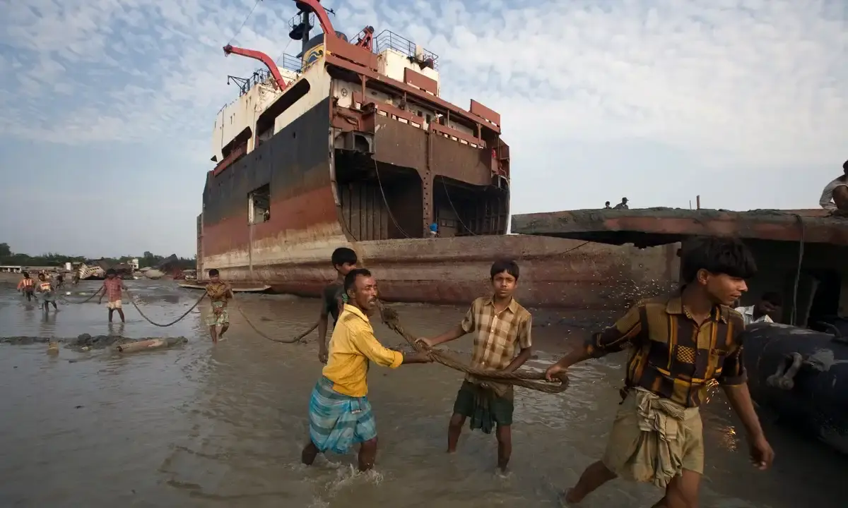 Shipbreakers haul cut hull sections ashore in Chittagong.webp